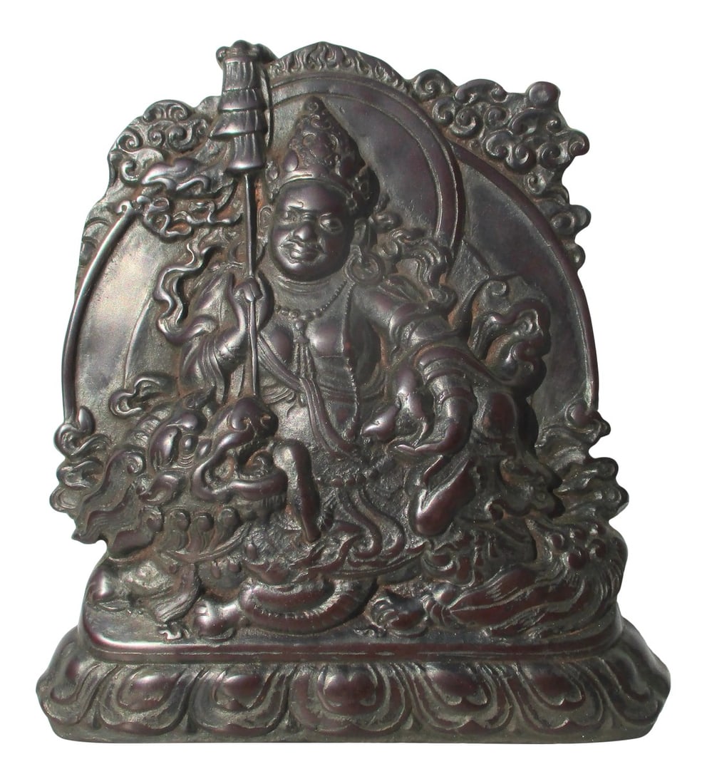 Tibetan Tree Resin Cast Lokapala on Lion: Reconstituted tree amber cast in Tibetan Tsa Tsa mold of one Lokapala divinity. Cast in a dark, opaque tree resin, a shallow bas-relief, polished over higher surfaces. The size is 6.25" wide by 7"