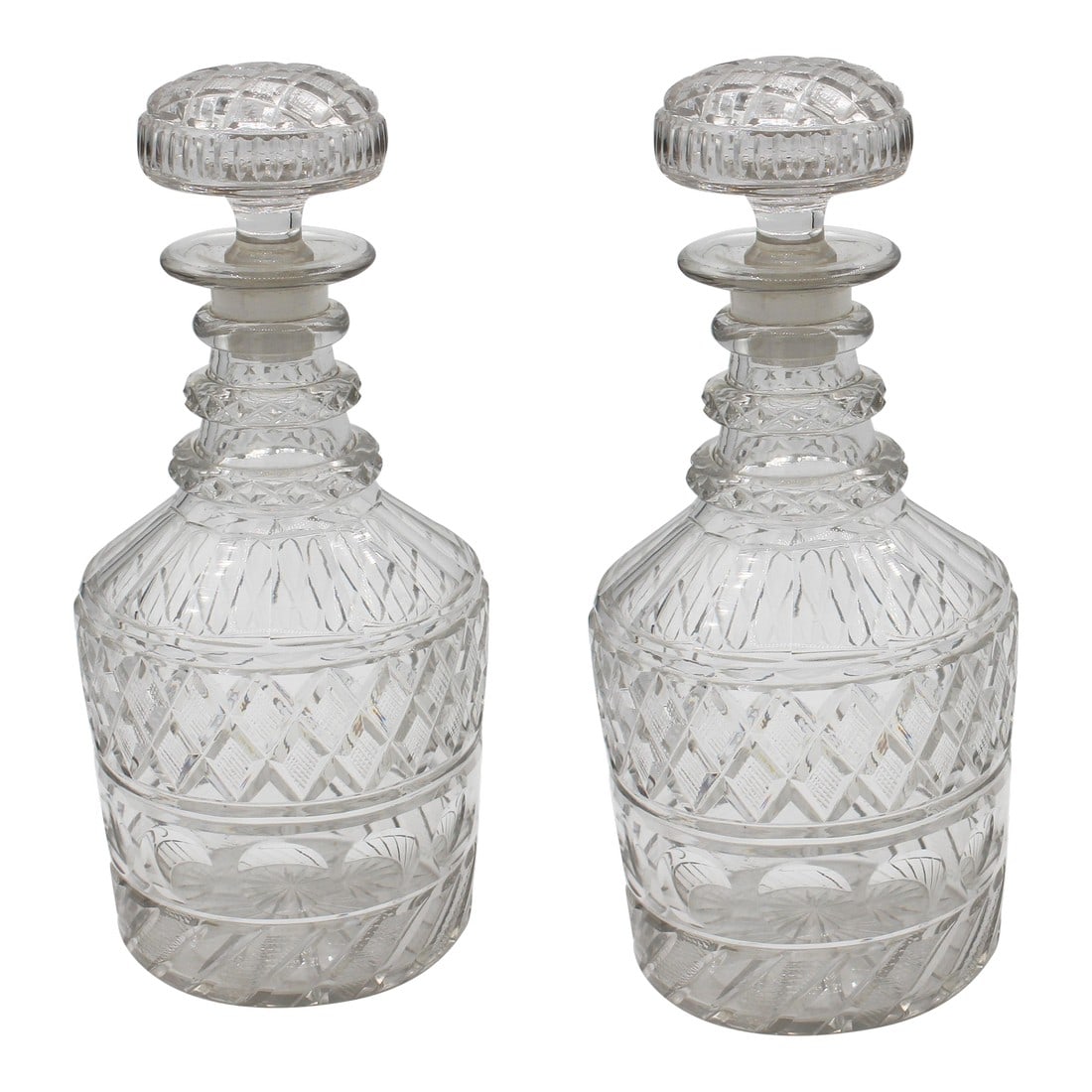 C. 1820 Pair of Georgian Anglo-Irish Cut Glass Decanters: Circa 1820 Pair of Georgian Anglo-Irish Cut Glass Decanters. Original stoppers. Panelled shoulders over diamond cut band, repeated on the stopper tops. Stopper ends with nibbles to one & chips to the 