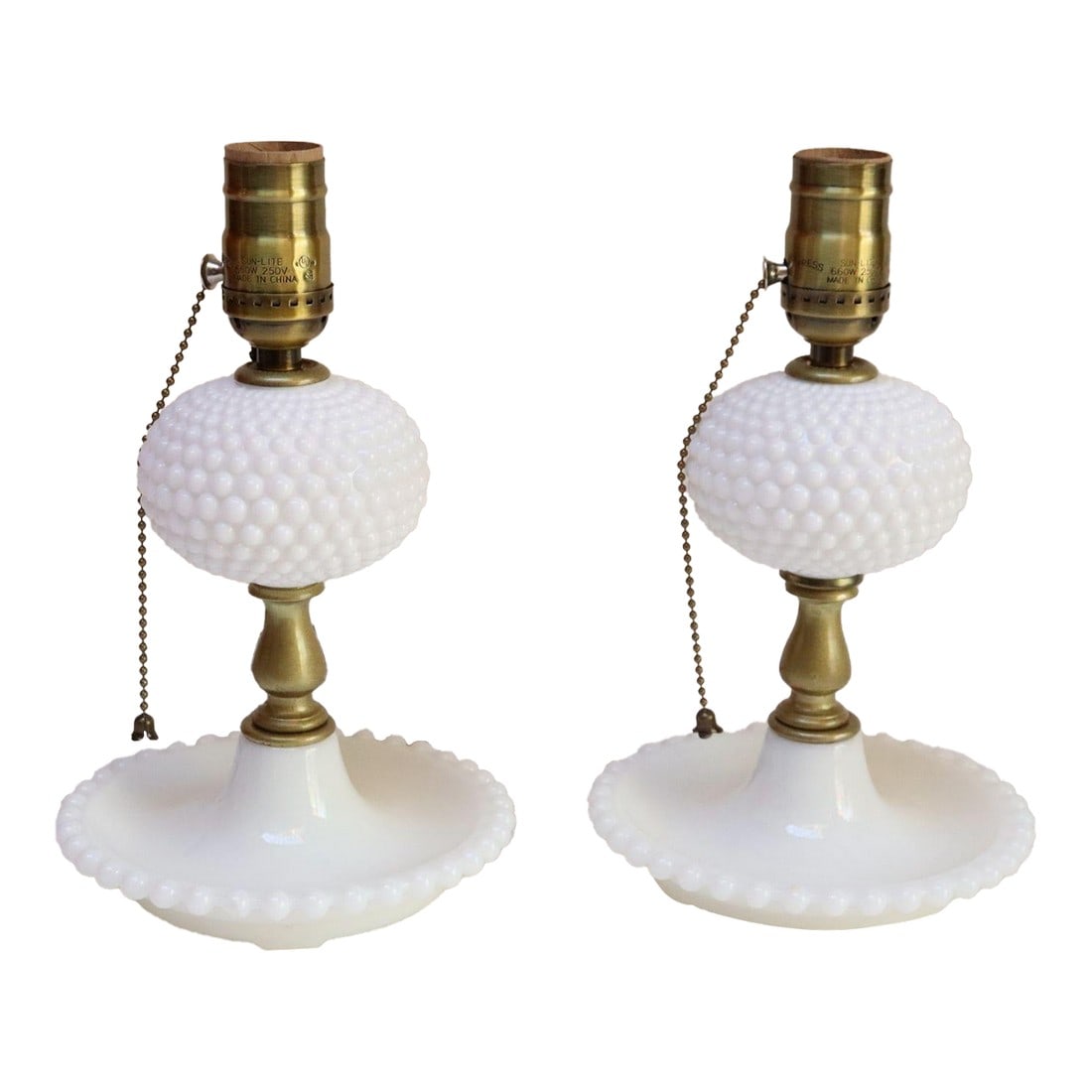 Pair of Petite Mid-Century Modern Hobnail Milk Glass Saucer Boudoir Bedside Table Lamps: Pair of petite vintage hobnail-form milk glass table lamps with saucer bases (ca. 1950, USA). Charming, elegant pieces to enhance a boudoir or bedside table emitting an attractive, soft light. There i