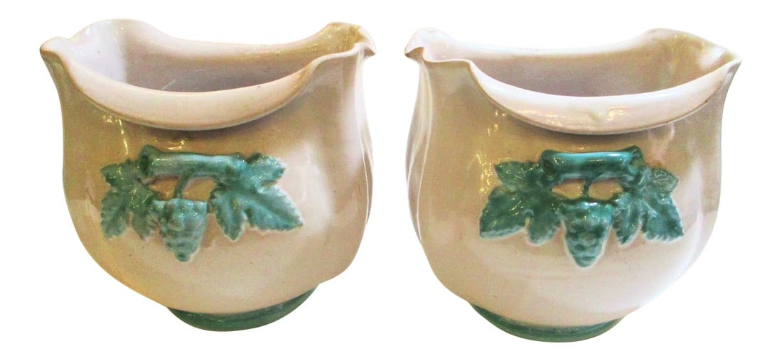 Vintage Italian Ceramic Cachepot - a Pair of 2: Vintage pair of Italian ceramic cachepot. Off white bodies with raised foliage forms in teal blue on front and back. Bombay forms with rolled lips. Classic 1950s' decorations. Marked to the bottom