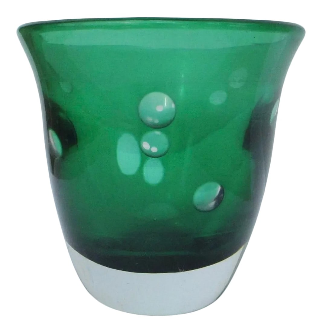 Kosta Boda Vintage Green and Clear Signed Vase: Kosta Boda deep green vase with heavy clear base and wall layer. Carved in circular disks in the wall to reveal a clear body and green inner layer. Signed to the bottom Kosta Boda. The size is 4.4"