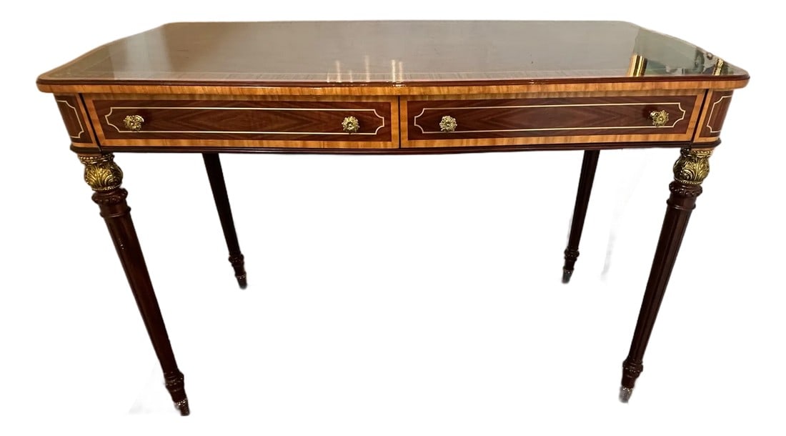 Theodore Alexander Mahogany Desk With Cast Brass Accents and Two Drawers: The gorgeous "Morley Desk" by top furniture maker Theodore Alexander, having 2 drawers, lovely turned and fluted legs with acanthus cast brass capitals and feet. Solid Mahogany & Figured Etimoe
