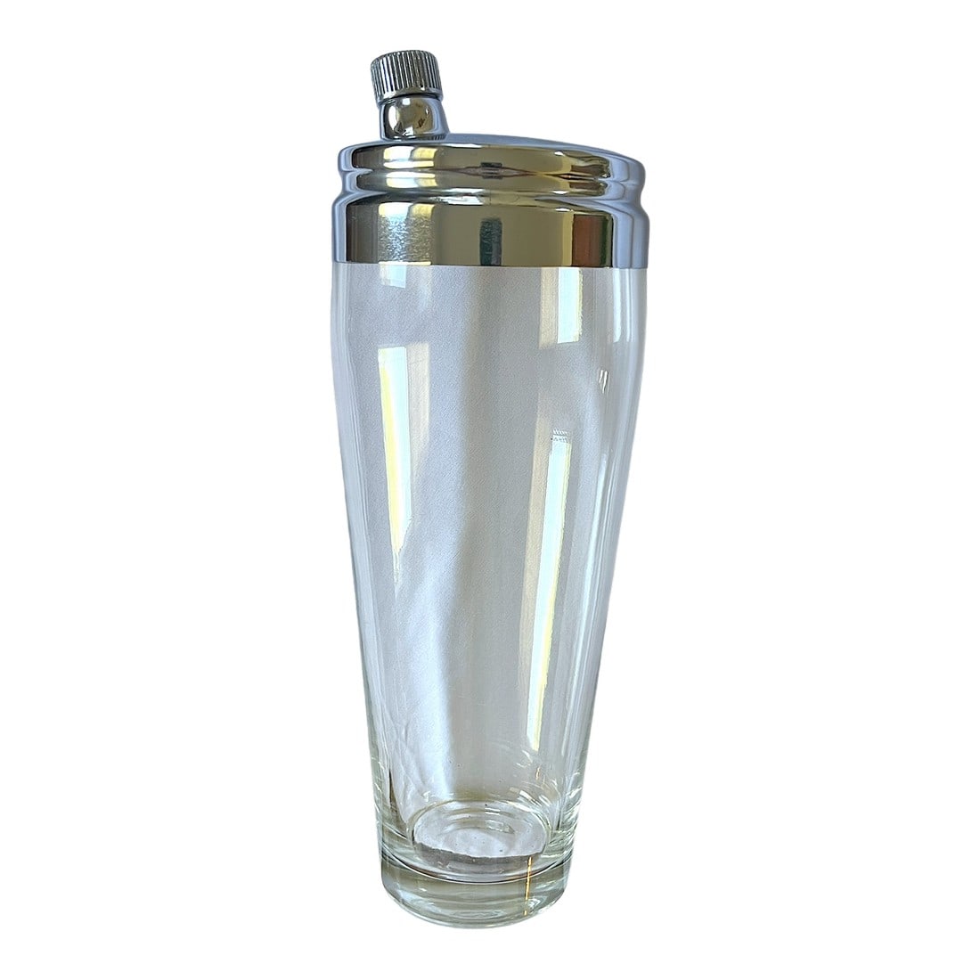 1950s Oversized Chrome & Frosted Glass Cocktail Shaker – Barware Classic After Ralph Lauren: A striking mid-century cocktail shaker featuring a substantial frosted glass body paired with a polished chrome lid and integrated strainer. The silhouette is clean and architectural, with a softly ta