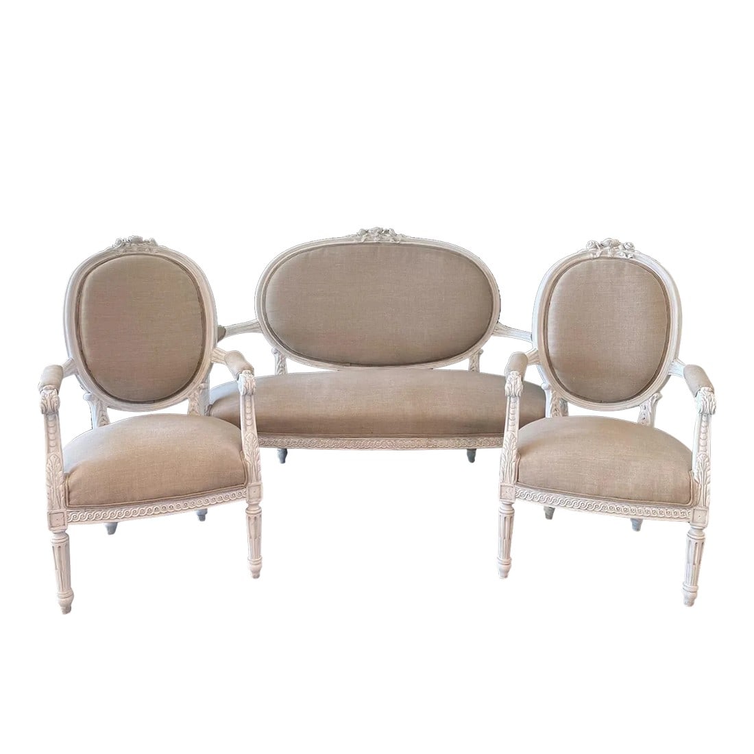 French Louis XVI Belle Epoque Parlor or Salon Set -Set of 3: A very pretty late 19th century three piece Louis XVI style parlor set consisting of a settee and a pair of arm chairs having beautiful carved designs on the painted arms and legs and classic oval