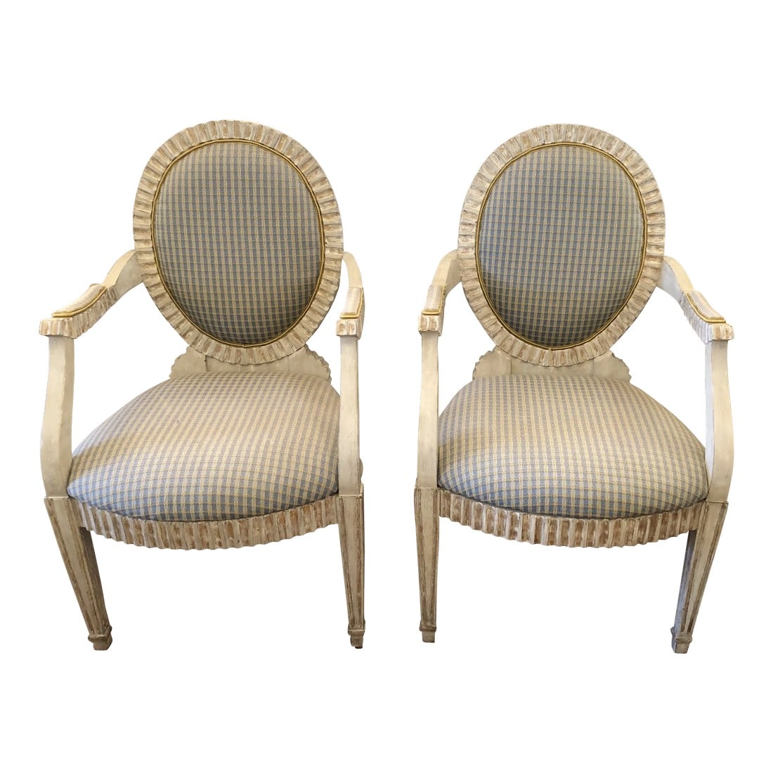 Faux Painted French Provincial Carved Wood Armchairs- a Pair: Substantial and heavy, beautifully carved and faux painted pair of Louis XVI style French Provincial armchairs having a cream antiqued color wood and charming light blue and gold checked upholstery.
