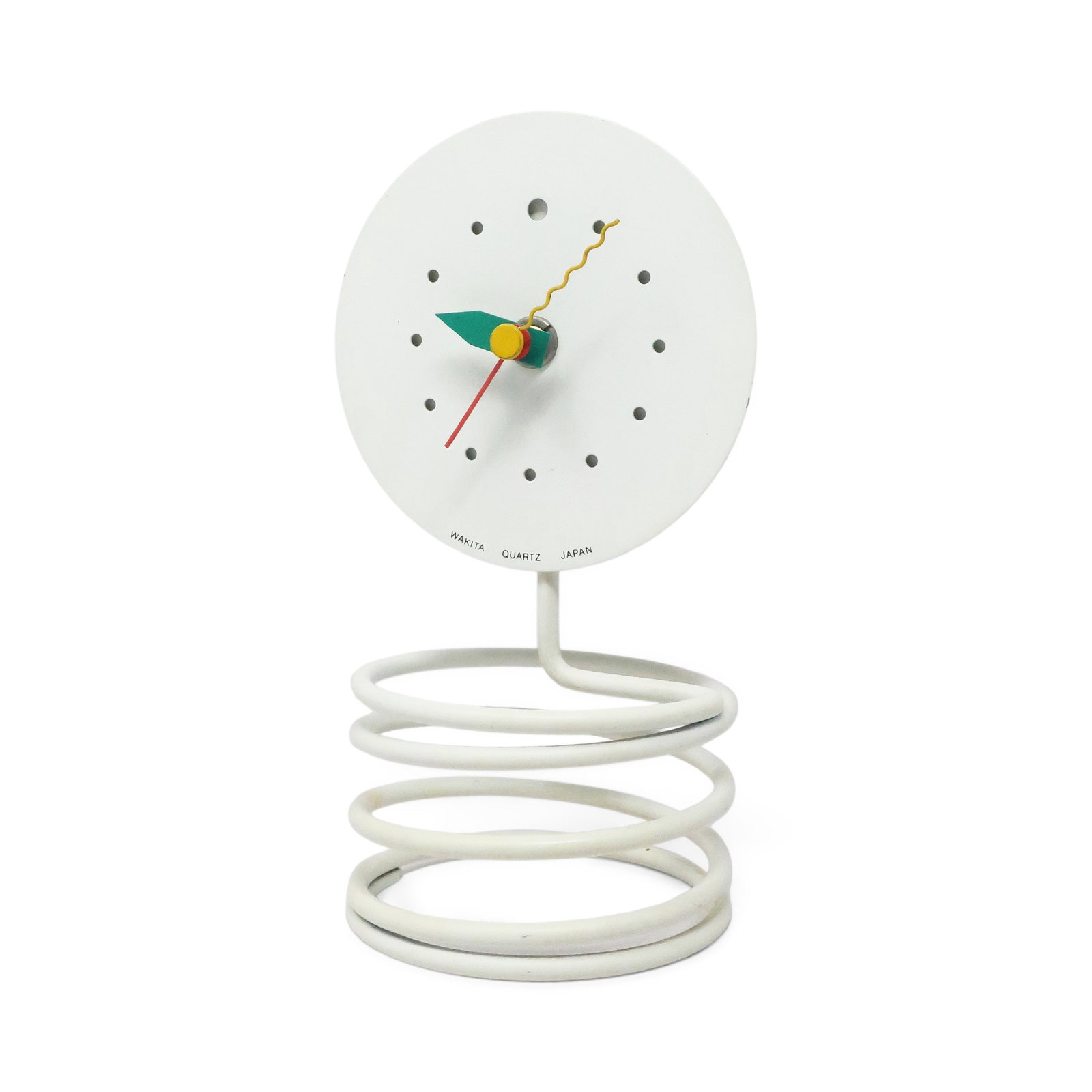 1980s Wakita Spring Table Clock: A striking postmodern table clock by Wakita featuring a sculptural white coiled spring base supporting a minimalist white face. The clean circular dial displays simple gray dot hour markers at each