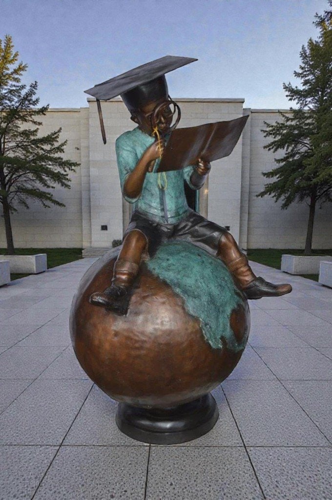 Student learning on top of world bronze statue - Size: 28"L x 24"W x 52"H. - 4