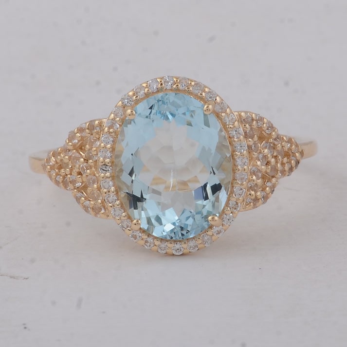 2.44 Ct Oval Aquamarine 9K Gold Ring: 2.44 Total Carat Aquamarine 9K Gold Ring Specifications: Total Weight 2.3 g Center Gemstone AquamarineGemstone Carat Weight 2.12 Carats Gemstone Measurements 10X8X4.50 mm Additional Gemstones White Sa