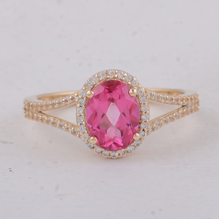 1.91 Ct Oval Pink Topaz 9K Gold Ring: 1.91 Total Carat Pink Topaz 9K Gold Ring Specifications: Total Weight 2.3 g Center Gemstone Pink Topaz Gemstone Carat Weight 1.64 Carats Gemstone Measurements 8X6 mm Additional Gemstones White Sapphir