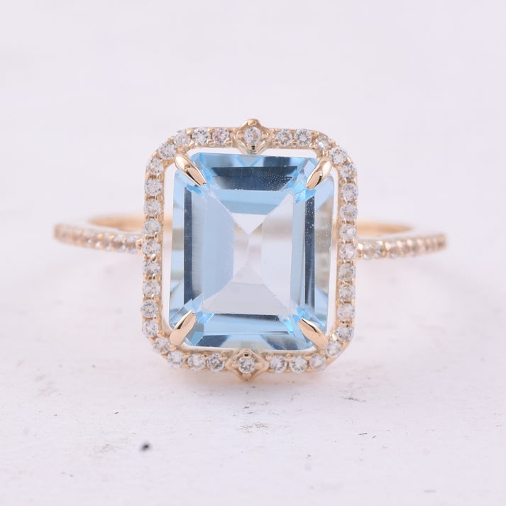 4.17 Ct Octagon Blue Topaz 9K Gold Ring: 4.17 Total Carat Blue Topaz 9K Gold Ring Specifications: Total Weight 2.439 g Center Gemstone Blue Topaz Gemstone Carat Weight 3.92 Carats Gemstone Measurements 10X8 mm Additional Gemstones White Sapp
