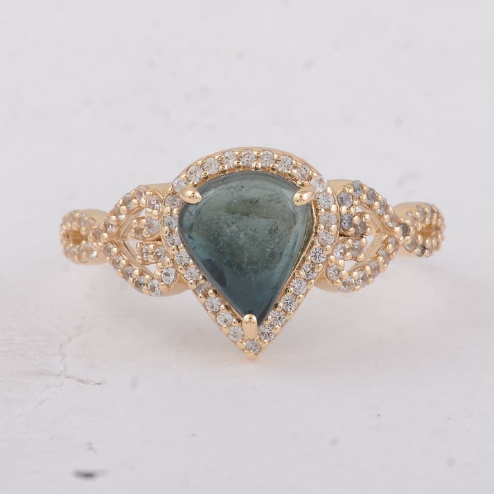 1.84 Ct Pear Tourmaline 9K Gold Ring: 1.84 Total Carat Tourmaline 9K Gold Ring Specifications: Total Weight 2.18 g Center Gemstone Tourmaline Gemstone Carat Weight 1.49 Carats Gemstone Measurements 8.30X7X3.10 mm Additional Gemstones Whit