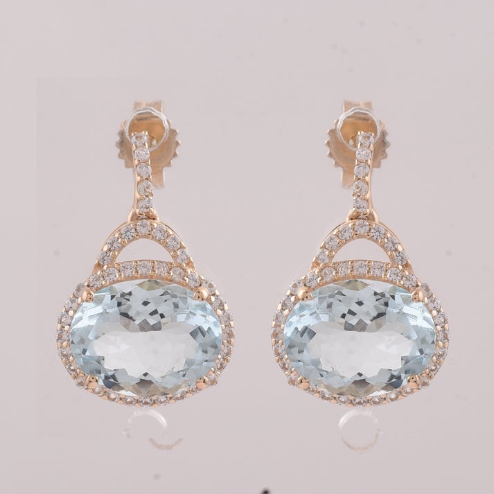 3.16 Ct Oval Aquamarine 9K Gold Earrings: 3.16 Total Carat Aquamarine 9K Gold Earrings Specifications: Total Weight 2.047 g Center Gemstone Aquamarine Gemstone Carat Weight 2.83 Carats Gemstone Measurements 9X7 mm Additional Gemstones White S