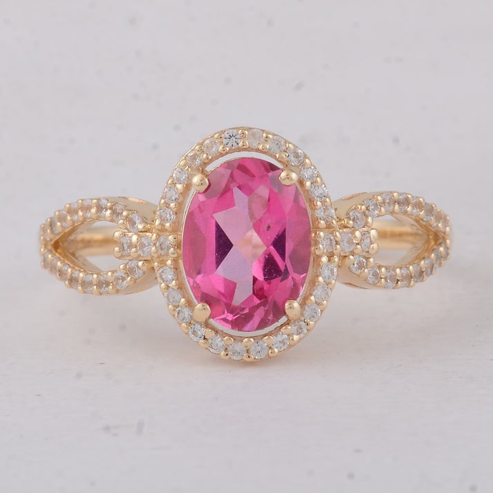 1.65 Ct Oval Pink Topaz 9K Gold Ring: 1.65 Total Carat Pink Topaz 9K Gold Ring Specifications: Total Weight 2.19 g Center Gemstone Pink Topaz Gemstone Carat Weight 1.38 Carats Gemstone Measurements 8X6 mm Additional Gemstones White Sapphi