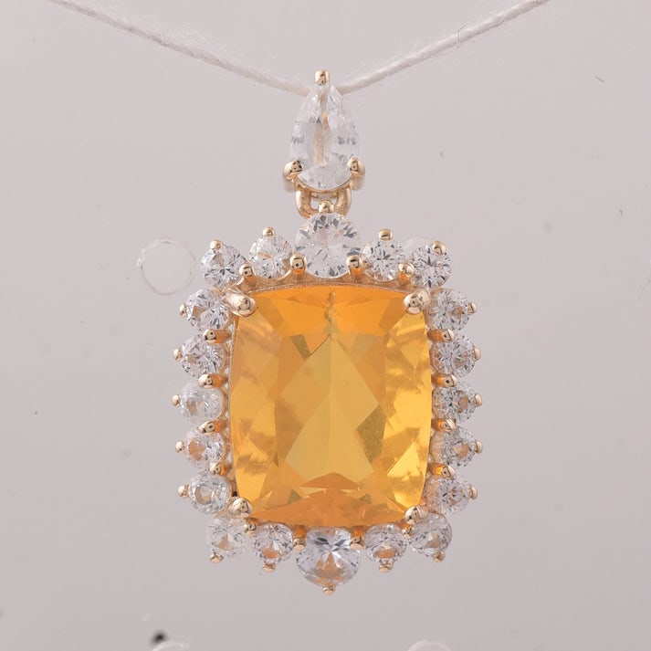 4.14 Ct Cushion Fire Opal 9K Gold Pendant: 4.14 Total Carat Fire Opal 9K Gold Pendant Specifications: Total Weight 1.866 g Center Gemstone Fire Opal Gemstone Carat Weight 2.84 Carats Gemstone Measurements 10.90X9X6.10 mm Additional Gemstones W