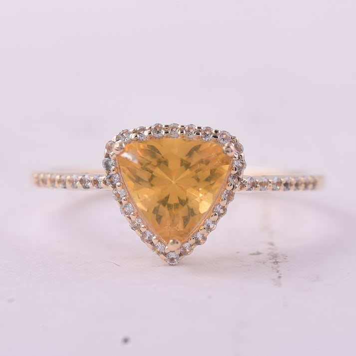 0.77 Ct Trillion Br.Fire Opal 9K Gold Ring: 0.77 Total Carat Br.Fire Opal 9K Gold Ring Specifications: Total Weight 1.439 g Center Gemstone Br.Fire Opal Gemstone Carat Weight 0.6 Carats Gemstone Measurements 7X7 mm Additional Gemstones White Sa