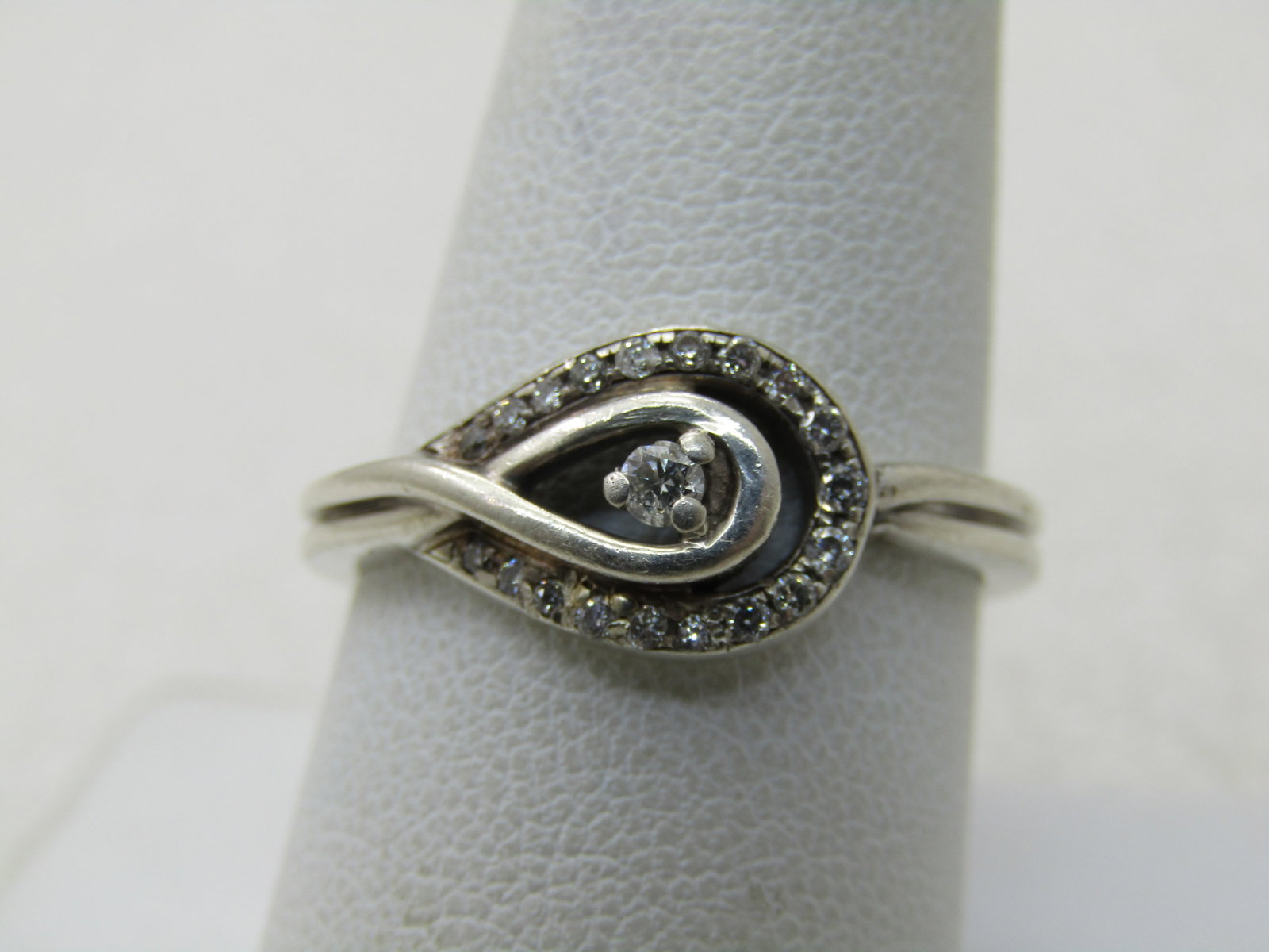 Vintage Sterling Silver Diamond Ring, Wrapped Halo, Sz. 9.5: Vintage Sterling Silver Diamond Ring, Wrapped Halo, Sz. 9.5. weight is papx. 3.64 grams. Signed with a double treardrop maker's mark. The center stone in inside a tear-drop frame and is appx. 2mm roun