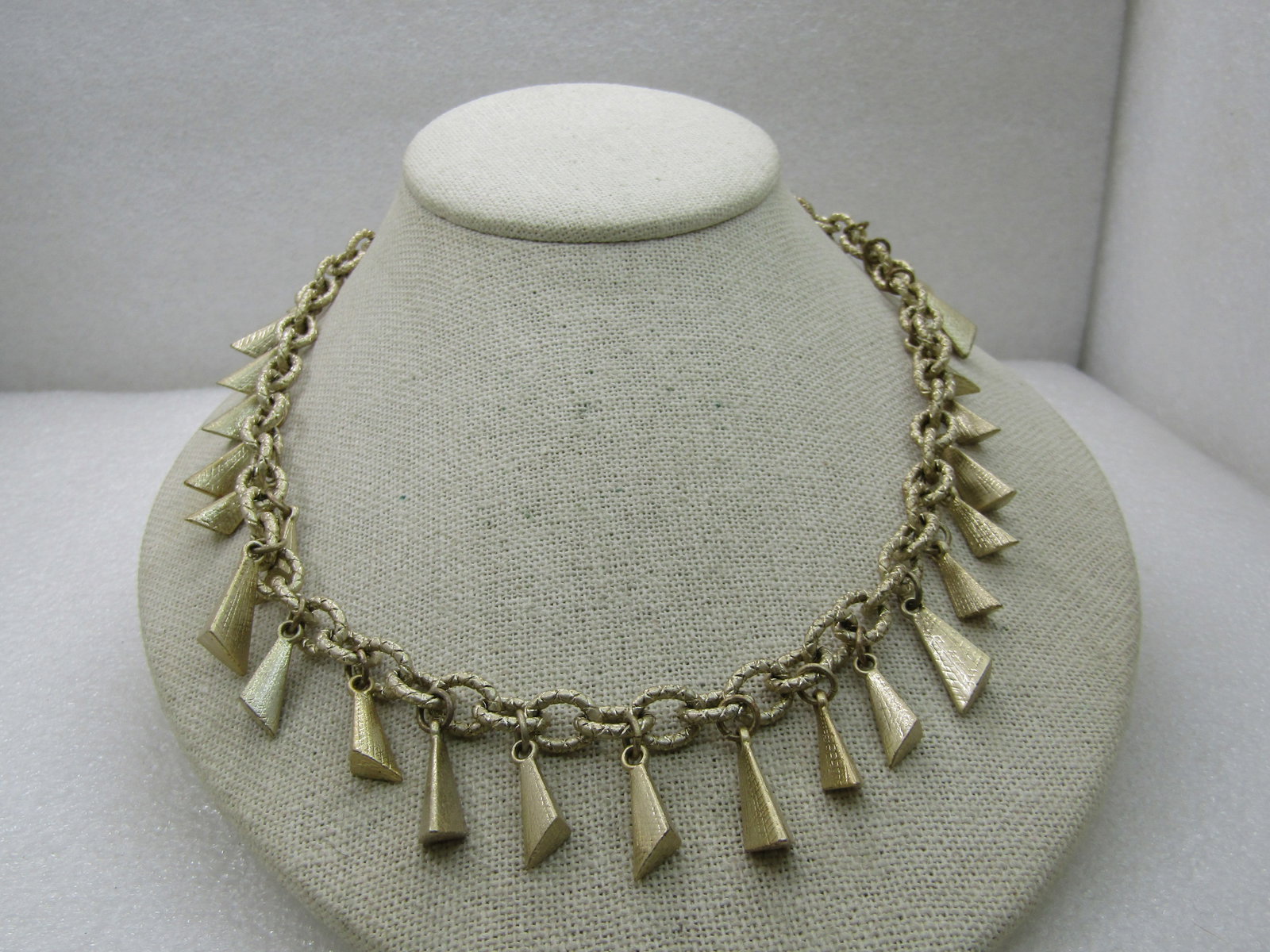 Lia Sophia Gold Tone Drop Necklace, 20": Lia Sophia Gold Tone Drop Necklace, 20", lobster clasp. It is 16" long with an appx. 4" extender chain. Heavy 8mm wide textured links with 3 sided drops that are appx. 1/2" to 3/4" long. Very good con