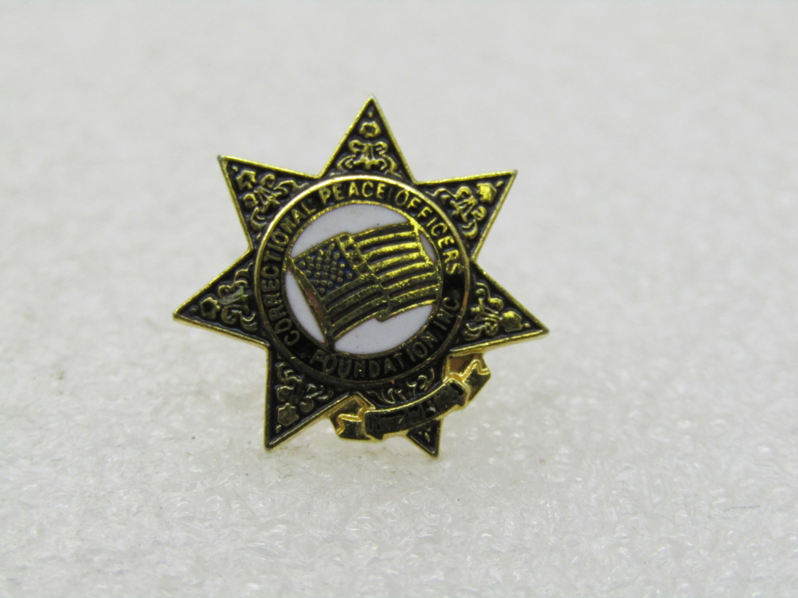 Vintage Correctional Peace Officer Enameled Tack Pin: Vintage Correctional Peace Officer Enameled Tack Pin, Pinted with enameling and USA flag in the center. It is appx. 16mm wide. 7 pointed accents with white enameled center and flag in the center. Gold