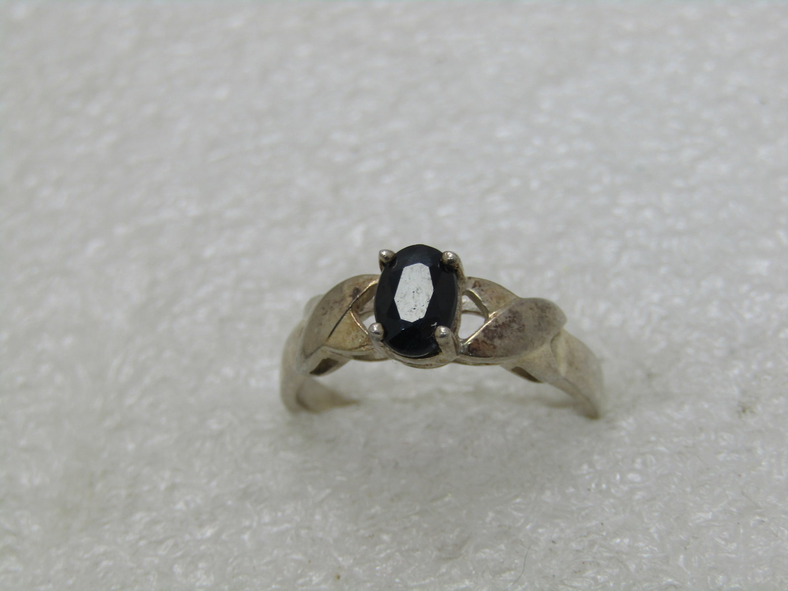 Vintage Sterling Black Spinel Ring, Criss-Cross Band, .75 CT, Sz. 8.25: Vintage Sterling Black Spinel Ring, Criss-Cross Band, .75 CT, Sz. 8.25, weight is appx. 2.83 grams. The band has an x-like design at the base of the stone on each side. The stone tests as black