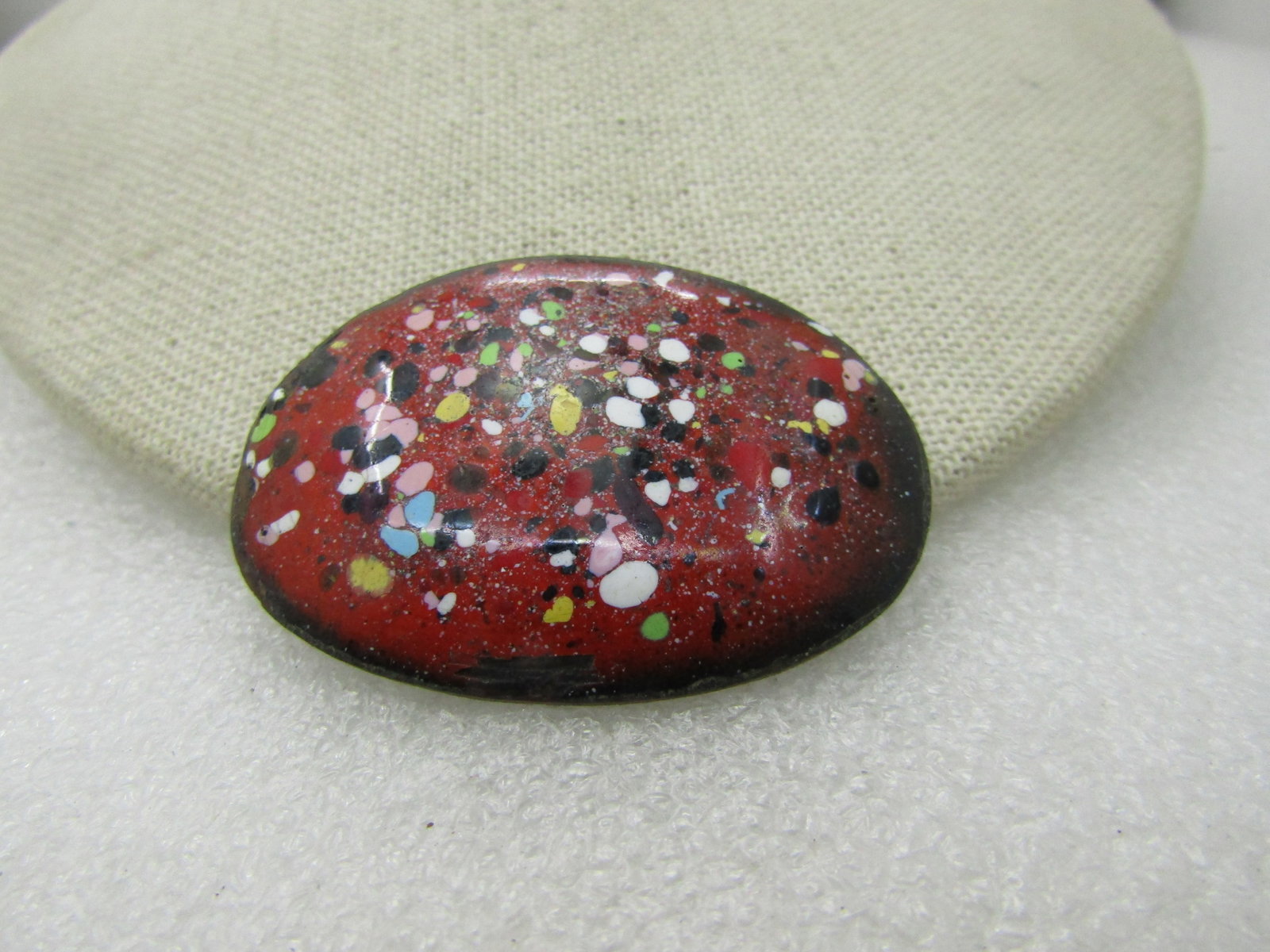 Vintage Enameled Copper Speckled Brooch, 1960's, 2": Vintage Enameled Copper Speckled Brooch, 1960's, 2" by 1-3/8". Domed, red background with green, yellow, black, white, pink speckles. Not signed by the maker. Very good condition. (INV> W27-20.15.8