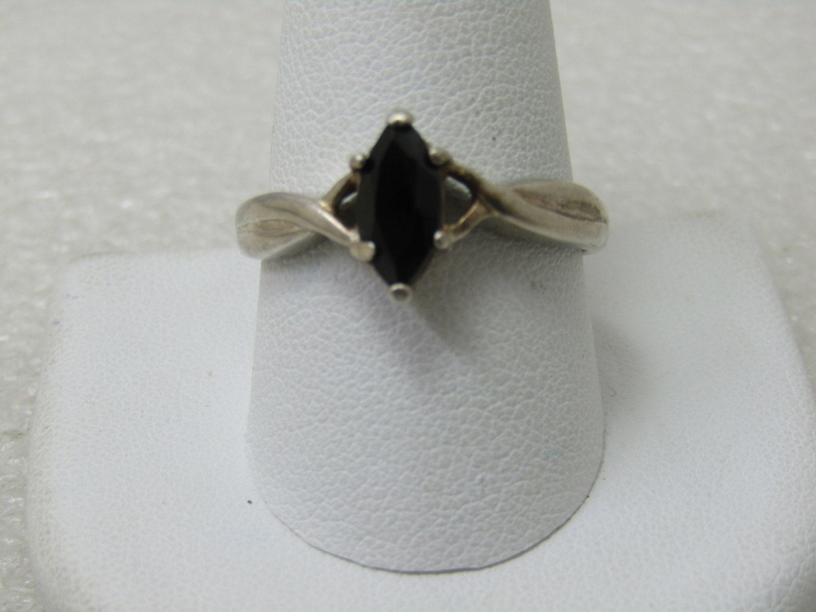 Vintage Sterling Silver Onyx Ring, Sz. 11, apx. .75 tcw: Vintage Sterling Silver Onyx Ring, Sz. 11, apx. .75 tcw. Cross-over band design with an open V at the sides of the stone. Prong-set stone. The band is appx. 4mm at the widest point and tapers down to 