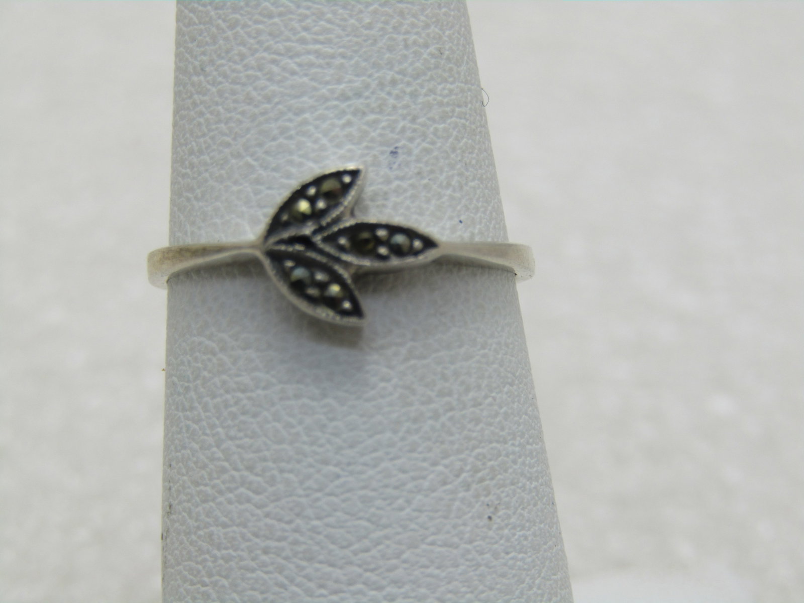 Vintage Sterling Silver Marcasite Leaf Ring, Sz. 6: Vintage Sterling Silver Marcasite Leaf Ring, Sz. 6, appx. 1.37 grams. Three little leaves, top is appx. 7.3mm by 7.5mm. The band is appx. 1.1mm on top and widens to appx. 2.2mm at the back of the