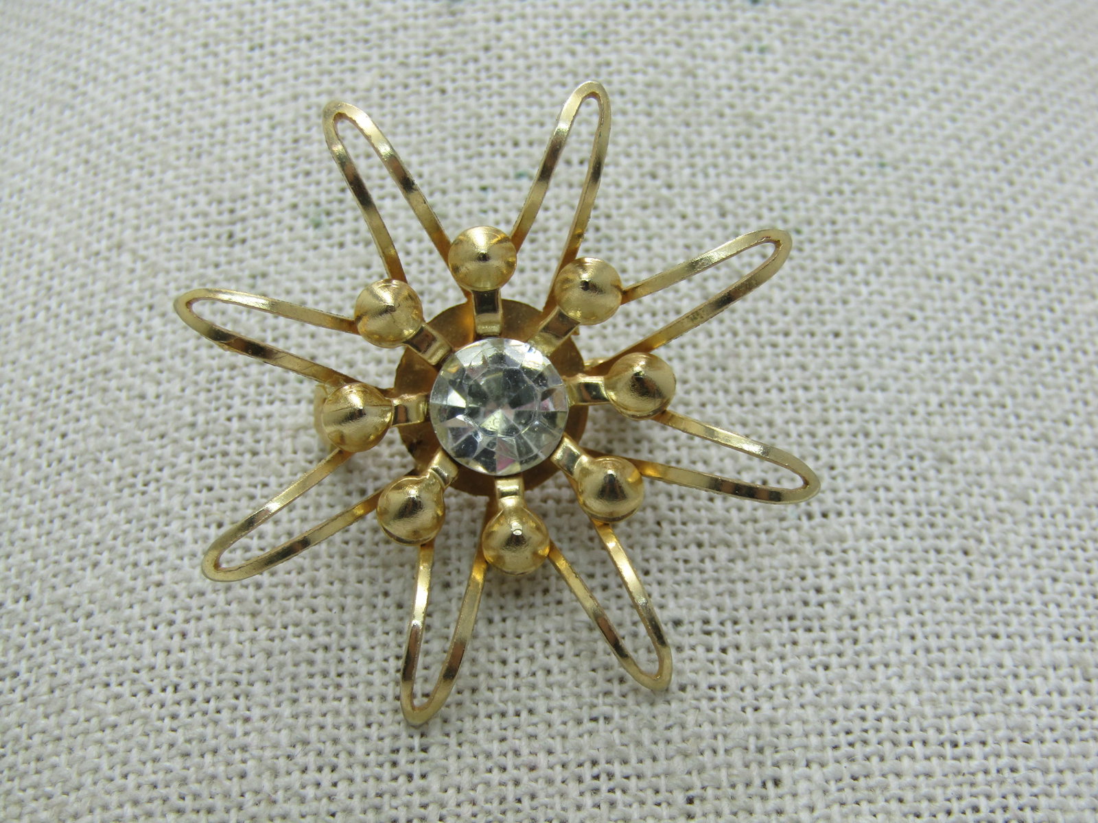 Vintage Rhinestone Starburst/Blossom Brooch, 1960's, Gold Tone: Vintage Rhinestone Starburst/Blossom Brooch, 1960's, Gold Tone, Recessed center with an 8mm clear rhinestone and rays (or petals) reaching upward and outward with bead accents. Slightly over 1.5" wide