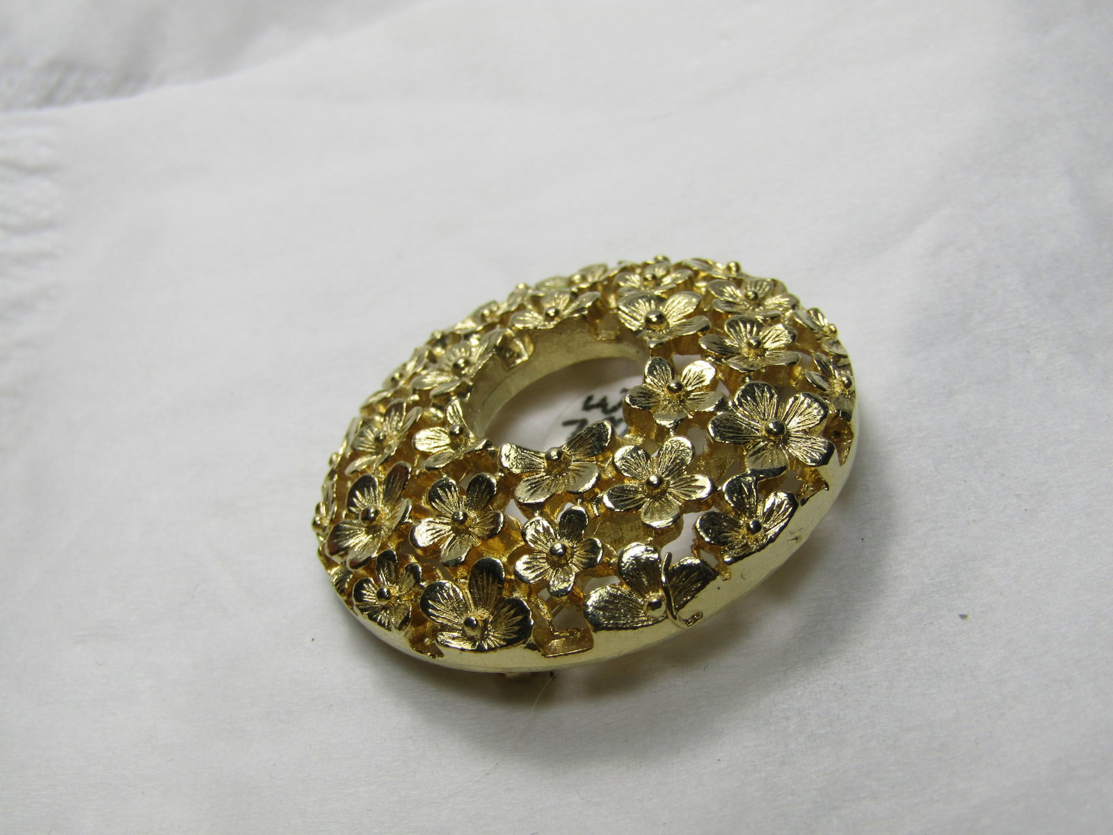 Vintage Forget-Me-Not Brooch, Gold Tone, 1.5": Vintage Forget-Me-Not Brooch, Gold Tone, 1.5" this has an open center with little blossoms scattered around the brooch in a triple row design, domed with an opening at top center. Very good