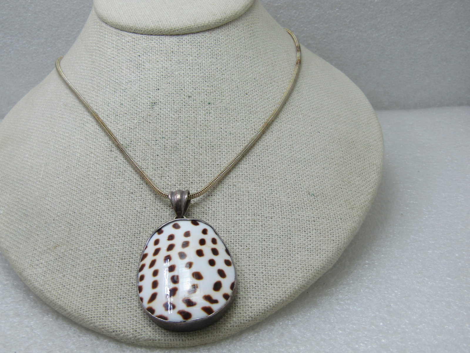 Vintage Sterling Silver Spotted Shell Necklace, 19", Snake Chain: Vintage Sterling Silver Spotted Shell Necklace, 19", Snake Chain. The pendant is domed and has a swing bail. It is appx. 5 grams and appx. 2-1/8" tall including bail and 1-3/8" wide, domed, bezel sent