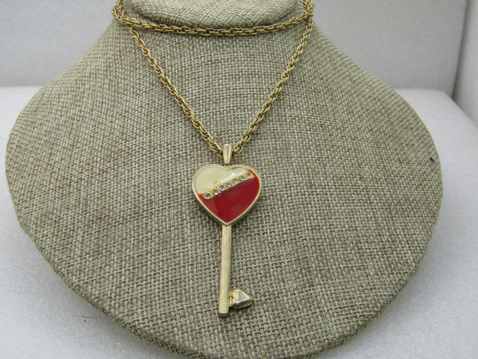Vintage Rhinestone Enameled Heart Key Necklace, 24": Vintage Rhinestone Enameled Heart Key Necklace, 24" Chain, 2.75" Pendant with red and white enameling and a r hinestone band diagonally crossing the heart. The chain is a rope chain that is appx. 2.5m
