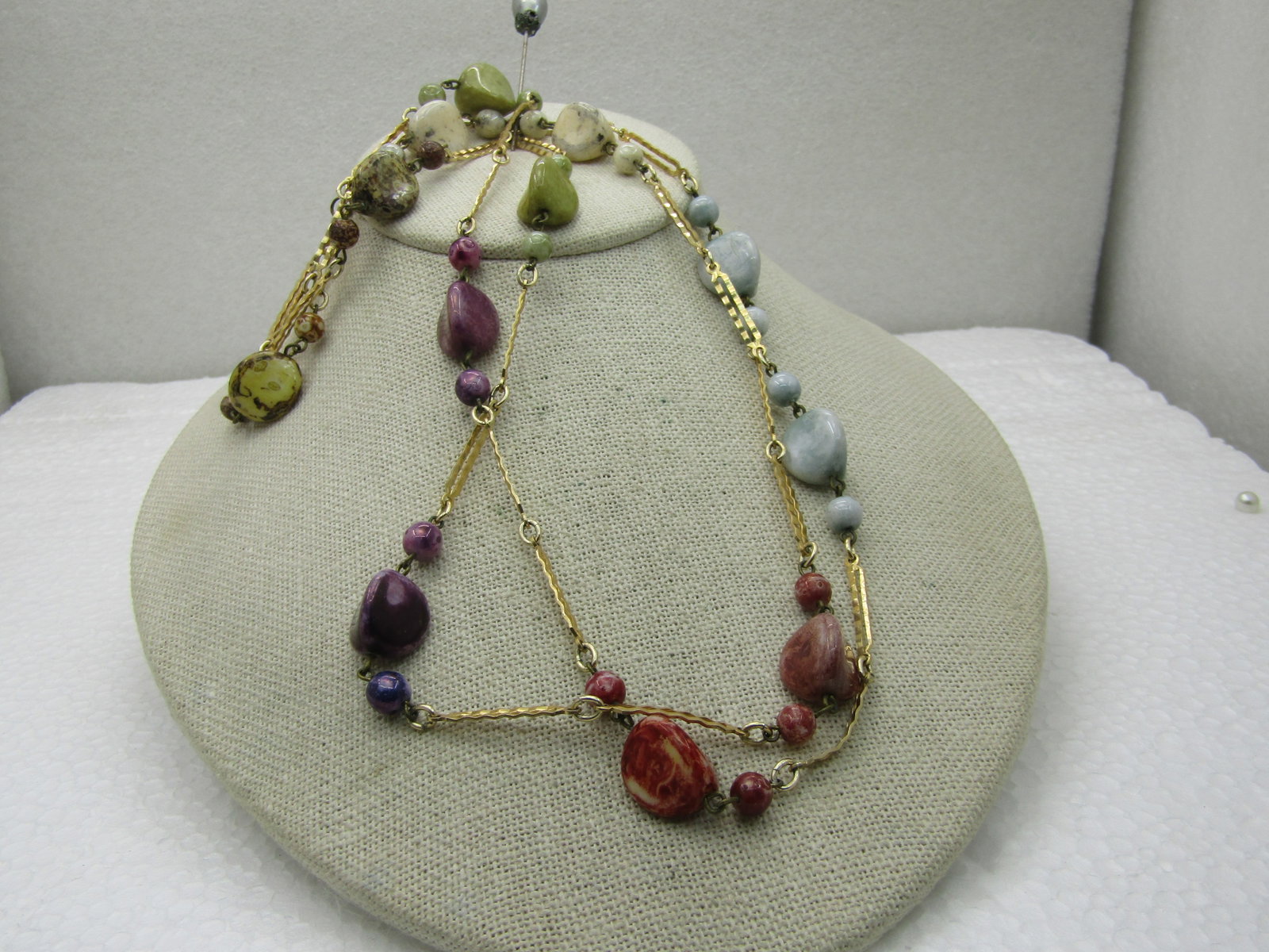 Vintage Gold Tone Dyed Stone Necklace, 44", Notched Bar Link, 1960's: Vintage Gold Tone Dyed Necklace, 44", Notched Bar Link, 1960's. Died triangular created plstic stones in iridescent and pearly finish in purple, blue, olive, cream, green, and a reddish color - each