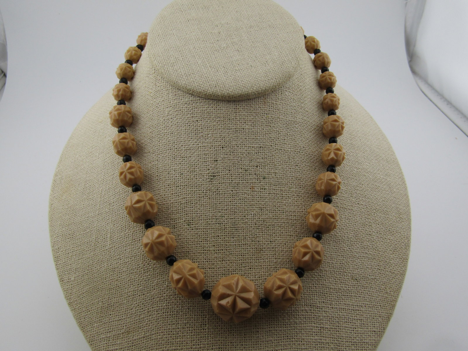 Vintage Tan/Black Graduated Pressed Glass Beaded Necklace, 17", 1950's-1960's (newer clasp): Vintage Tan/Black Graduated Pressed Glass Beaded Necklace, 17", 1950's-1960's (newer clasp). The necklace has tan ridged pressed glass beads that are graduated from 8mm to 18.5mm round with a black gl