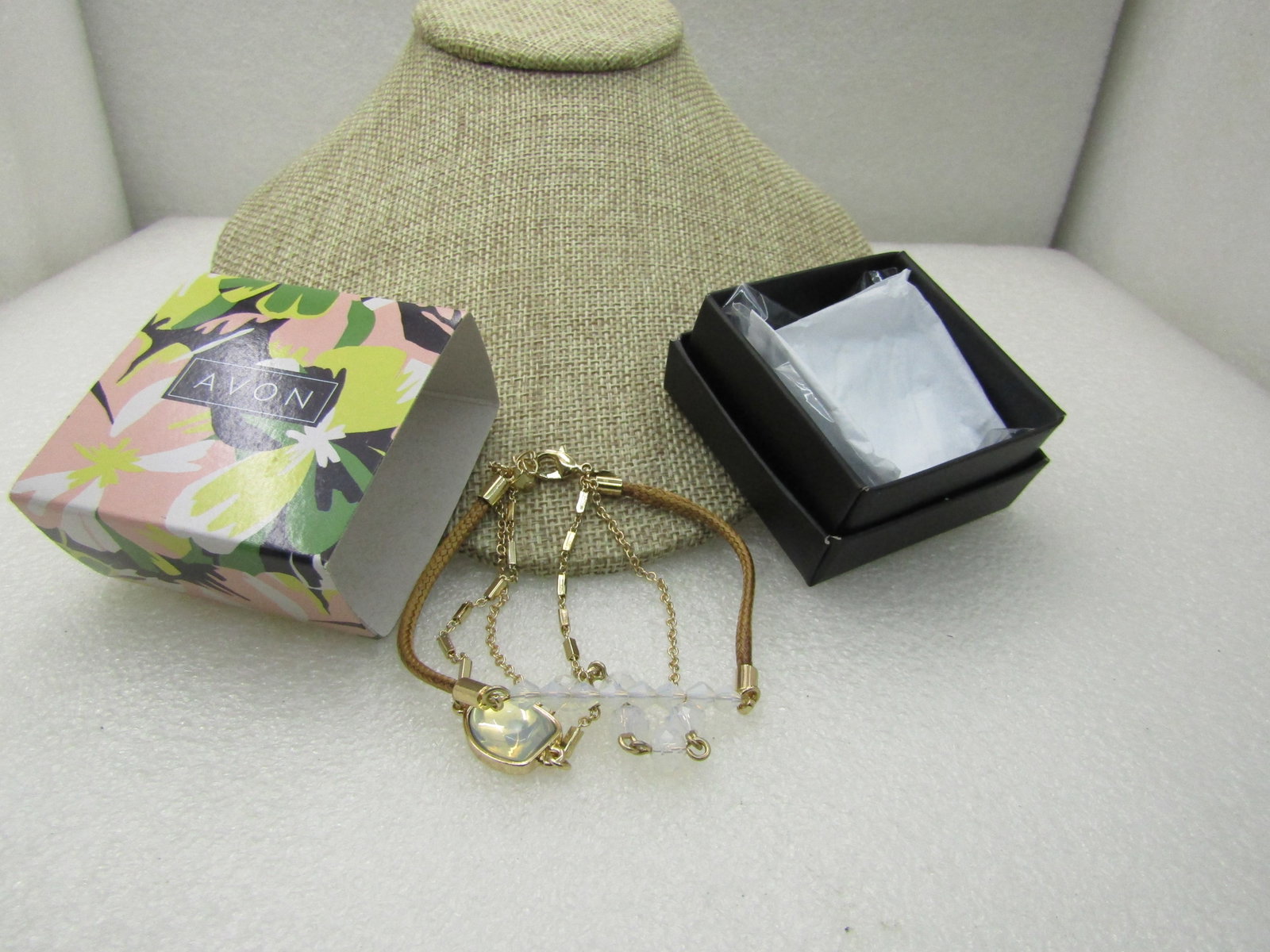 Avon Multi-Strand Opalesque Layered Bracelet. 7-8", In Original Box, Unworn: Avon Multi-Strand Opalesque Layered Bracelet. 7-8", In Original Box, Unworn. 2019 triple strand Opalesque bracelt by Acvon. Gold tone braided corn, bar link and chain lik with center Opally glass tone