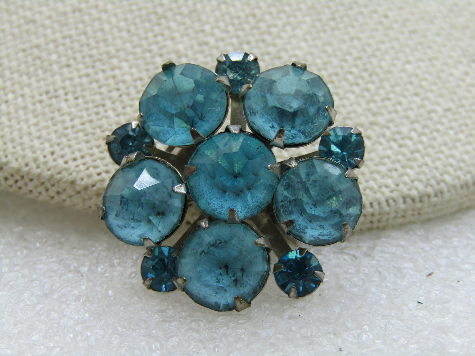 Vintage Aqua Rhinestone Blossom Brooch, 1960's: Vintage Aqua Rhinestone Blossom Brooch, 1960's, 1" wide with six 8mm rhinest ones, prong-set and 4mm rhinestones between each of the larger rhinestones on the outer edge. Silver Tone. Good to very
