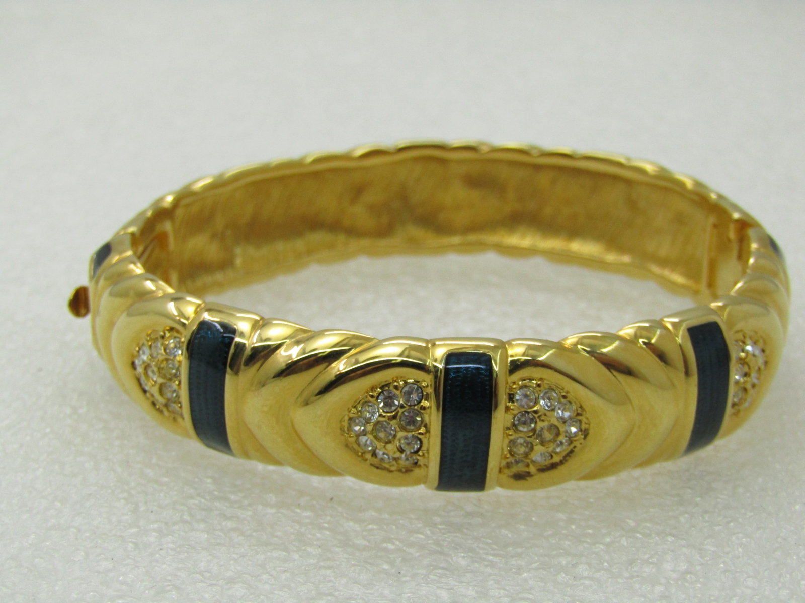 Vintage Joan Rivers Blue Enameled Hinged Bracelet, Pave CZ, 7", 14mm: Vintage Joan Rivers Blue Enameled Hinged Bracelet, Pave CZ, 7", 14mm, Clear CZs pave set in a near heart shape with bands of metallic dark blue enameled bands across the bracelet. Opening is 2.5" by 2
