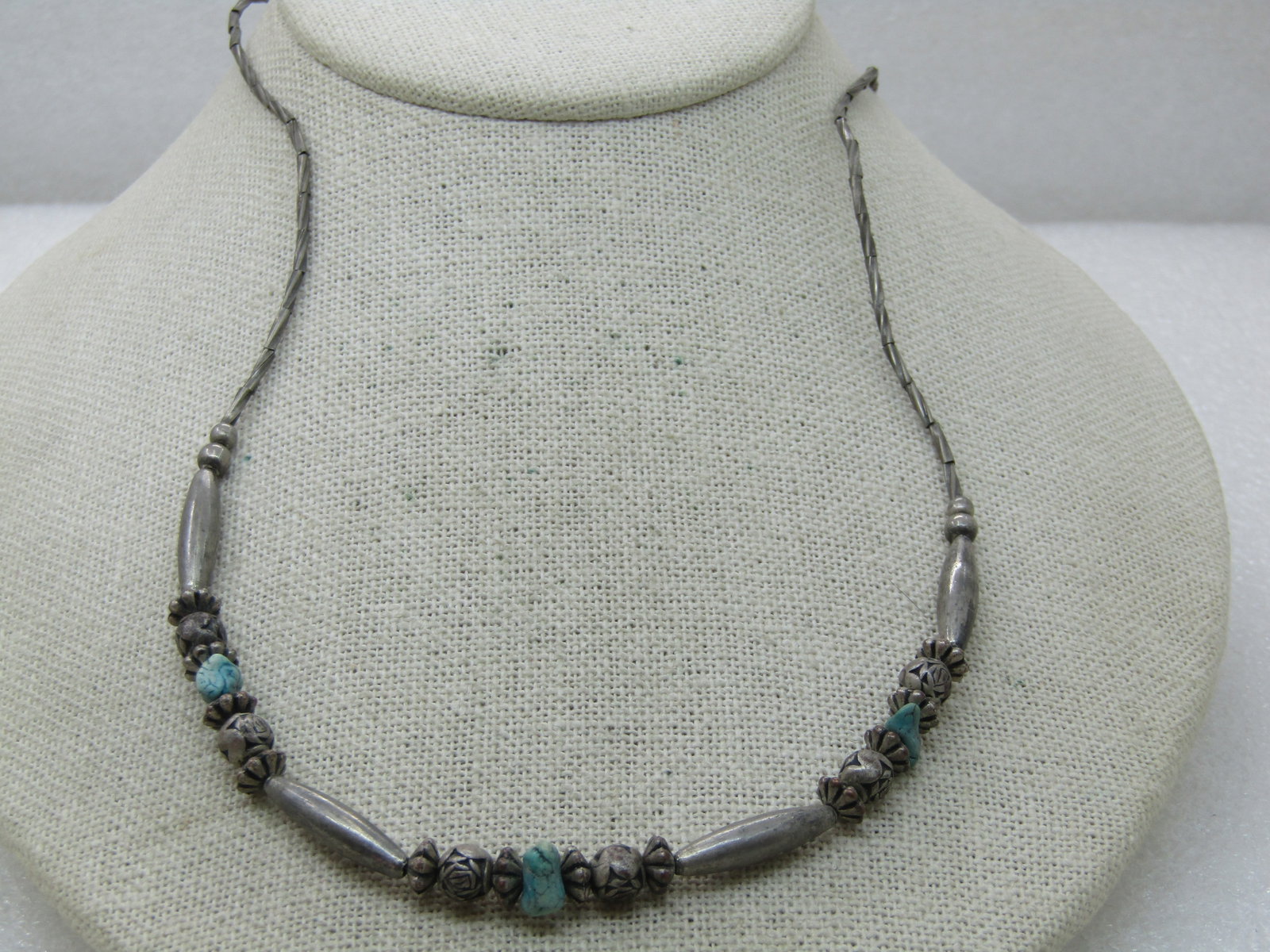 Vintage Southestern Turquoise & Beaded Necklace, 20": Vintage Southestern Turquoise & Beaded Necklace, 20", silver tone fluted and decorate veads with nearly 1" oblong tapered beads and three turquoise nuggets. The beads look like vintagbe sterling but d