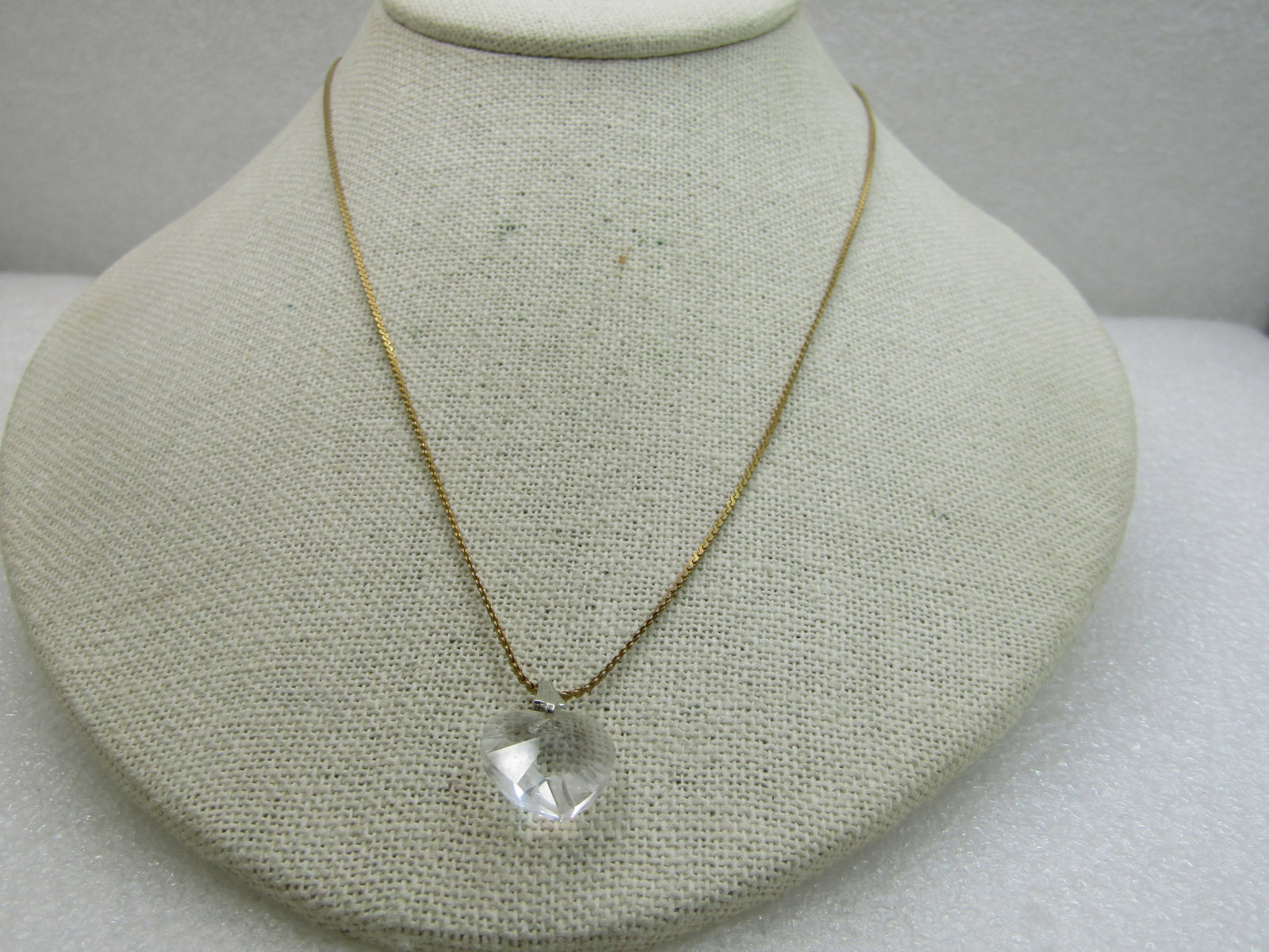 Vintage Crystal Heart Necklace, 18" Herringbone Chain: Vintage Crystal Heart Necklace, 18" Herringbone Chain. The bail on the heart is silver tone and the chain is a 1mm gold tone herringbone chain signed Korea with spring clasp. The heart is a cut