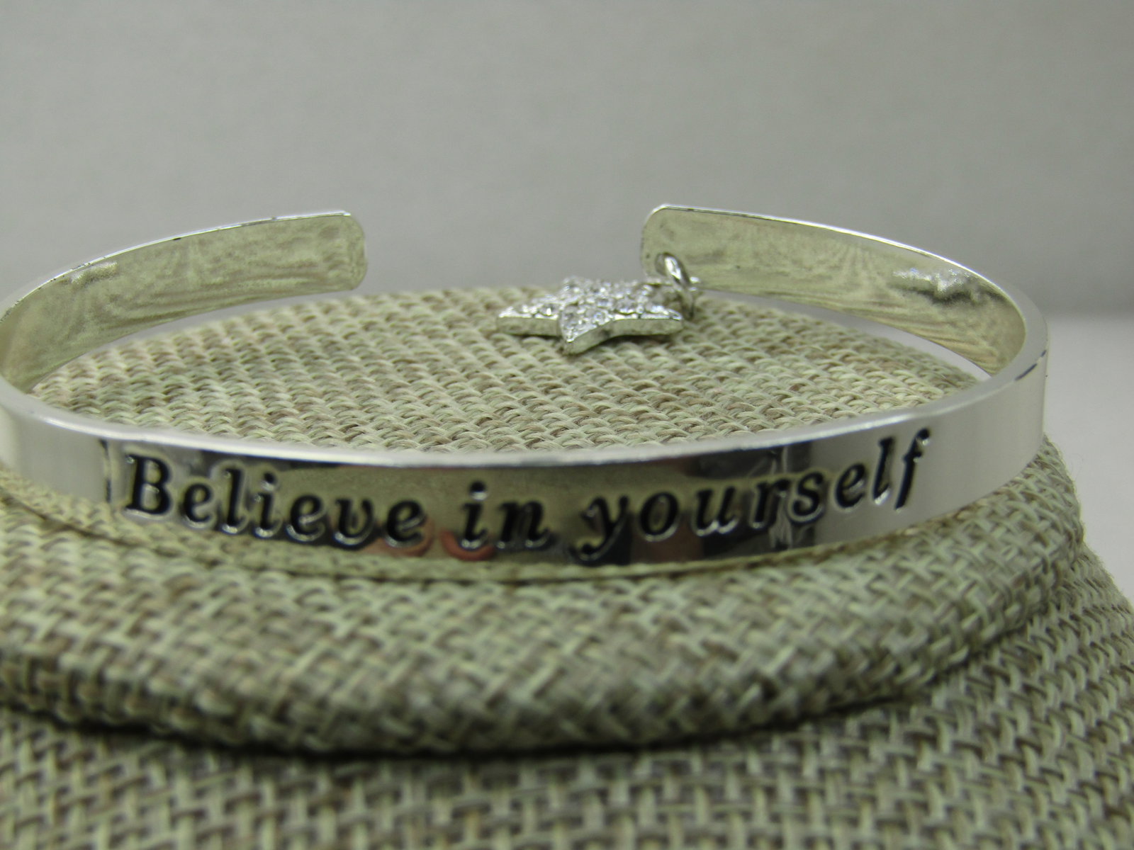 Avon My Truth Charm Cuff Bracelet, 6.75" Believe in yourself with Rhinestone Star: Avon My Truth Charm Cuff Bracelet, 6.75" Believe in yourself with Rhinestone Star. 2015, new in box with Sleeve. 6mm wide silver tone cuff with a 5/8" dangle rhinestone star at the back on one side. O