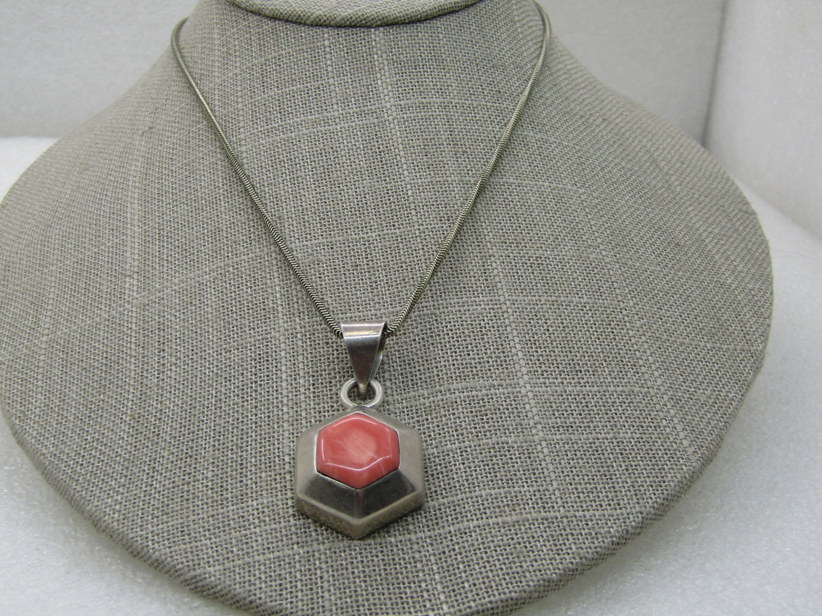 Sterling Silver Southwestern Necklace, 18.5", Simulated Pink Agate: Sterling Silver Southwestern Necklace, 18.5", Simulated Pink Agate, 6-sided pendant with a large swing bail. 1.5" long pendant that is slightly over 3/4" wide. Center pink simulated agate stone, likel