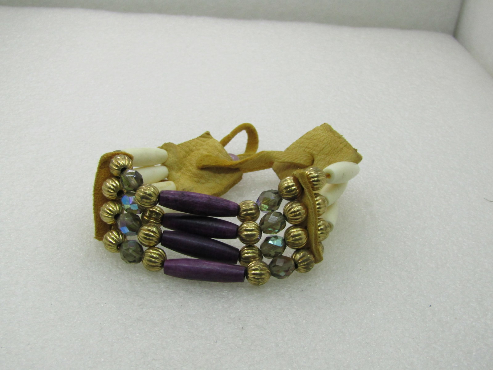 Vintage Southwestern Modern Tribal Bracelet, Adjustable: Vintage Southwestern Modern Tribal Bracelet, Adjustable. Four strands that have antelope-like 1" tube beads in natural color and purple dyed in the center. There are fluted or ridged 7.5mm gold tone
