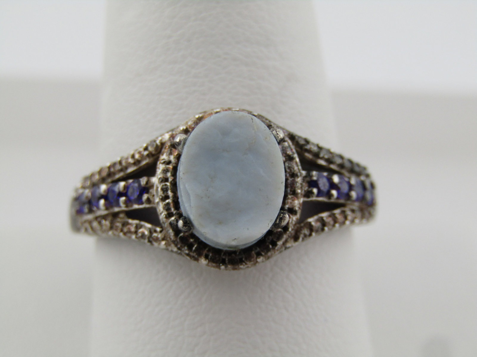 Sterling Dark/Light Blue Stone Ring, Sz. 10.5, Signed STS, 1990's: Sterling Dark/Light Blue Stone Ring, Sz. 10.5, Signed STS, 1990's. This has an oval piece of what appears to be glass. It is light blue with a textured stone on top that is appx. 8.5mm by 7mm. It is 4