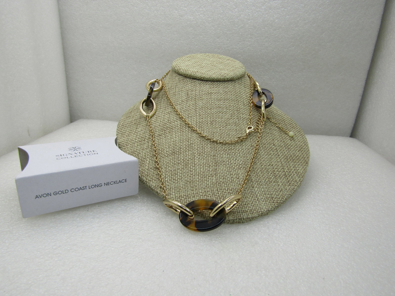 Avon Multi-Strand Opalesque Layered Bracelet. 7-8", In Original Box, Unworn: Avon Multi-Strand Opalesque Layered Bracelet. 7-8", In Original Box, Unworn. Gold tone and cateye faux tortoiseshell links set in cluster with gold chain. 38" long with 3" extender chain, lobster clap