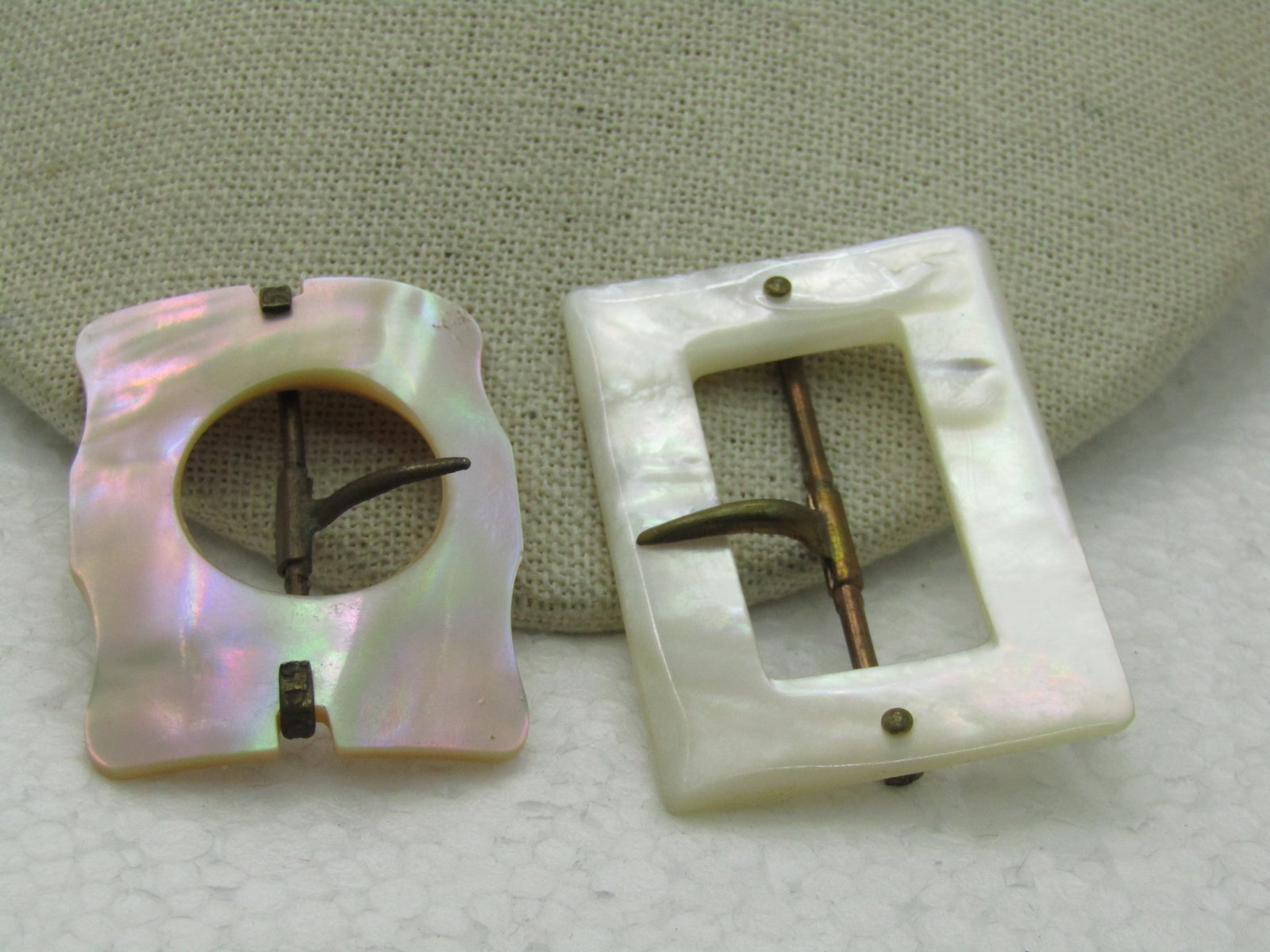 Vintage Early 1900's Mother-of-Pearl Buckles, Domed: Vintage Early 1900's Mother-of-Pearl Buckles, Domed, Rectangular is 2" by 1.5" - it does need a slight repair on the back to attach the bar to the nail. The other is a more domed rectangularish shape