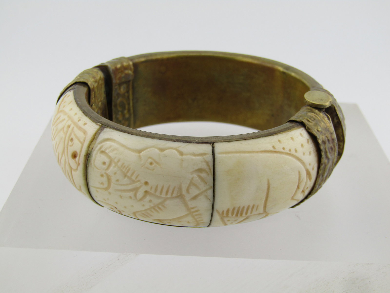 Vintage Carved Elephant/Lion Hinged Cuff Bracelet, Pin Clasp, 1960's-1970'a: Vintage Carved Elephant/Lion Hinged Cuff Bracelet, Pin Clasp, 1960's-1970's. This is brass stamped metal on the hinged and clasp ends and the inside of the carved bone bracelet. It has a domed carved 