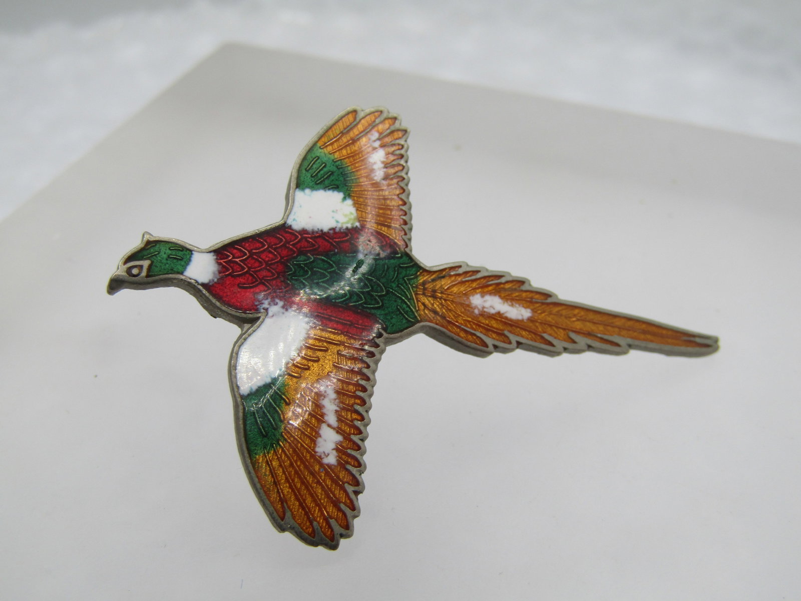Vintage Enameled Pheasant Tack Pin, 2", 1970's-1980's: Vintage Enameled Pheasant Tack Pin, 2", 1970's-1980's. Gold tone base with enameling in golden hues, green, red and white. Bird in flight pose. Very good condition. Not signed by the maker. W12823.4 S
