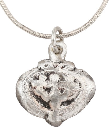 ANCIENT VIKING HEART PENDANT NECKLACE, C.866-1067 AD: Silvered bronze. Just under ¾” (0.72”) width. Broad heart form with central incised trefoil of especially elaborate and stylized configuration. High domed form with rounded edges.