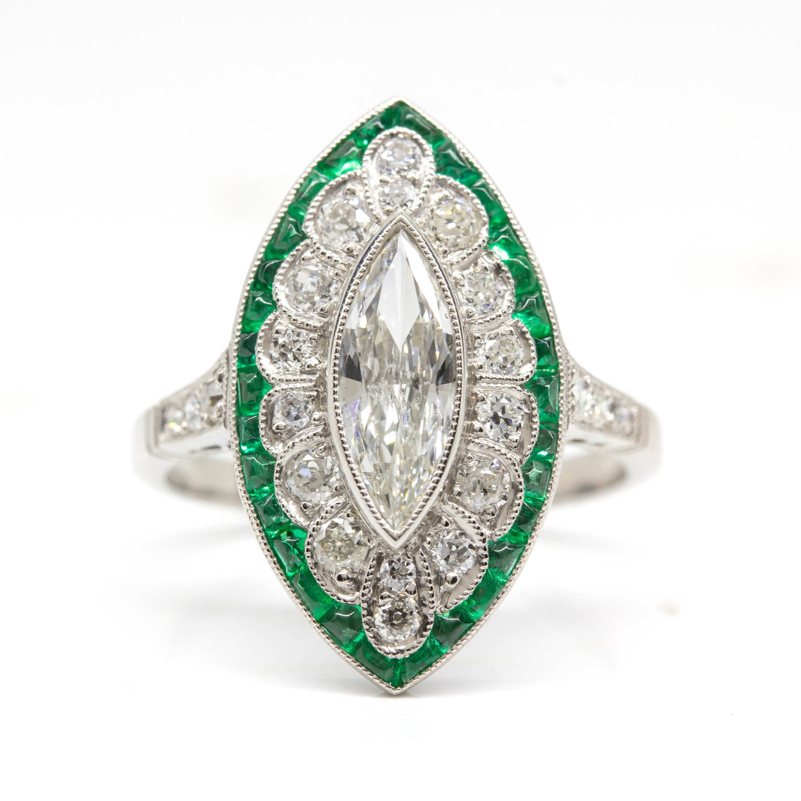 Handmade Platinum Ring with Antique Marquise Diamond and Emeralds: Title: Handmade Platinum Ring with Antique Marquise Diamond and Emeralds Description: The Amy ring is a piece handmade in platinum. It centers one old mine marquise cut diamond of J-K color and SI1