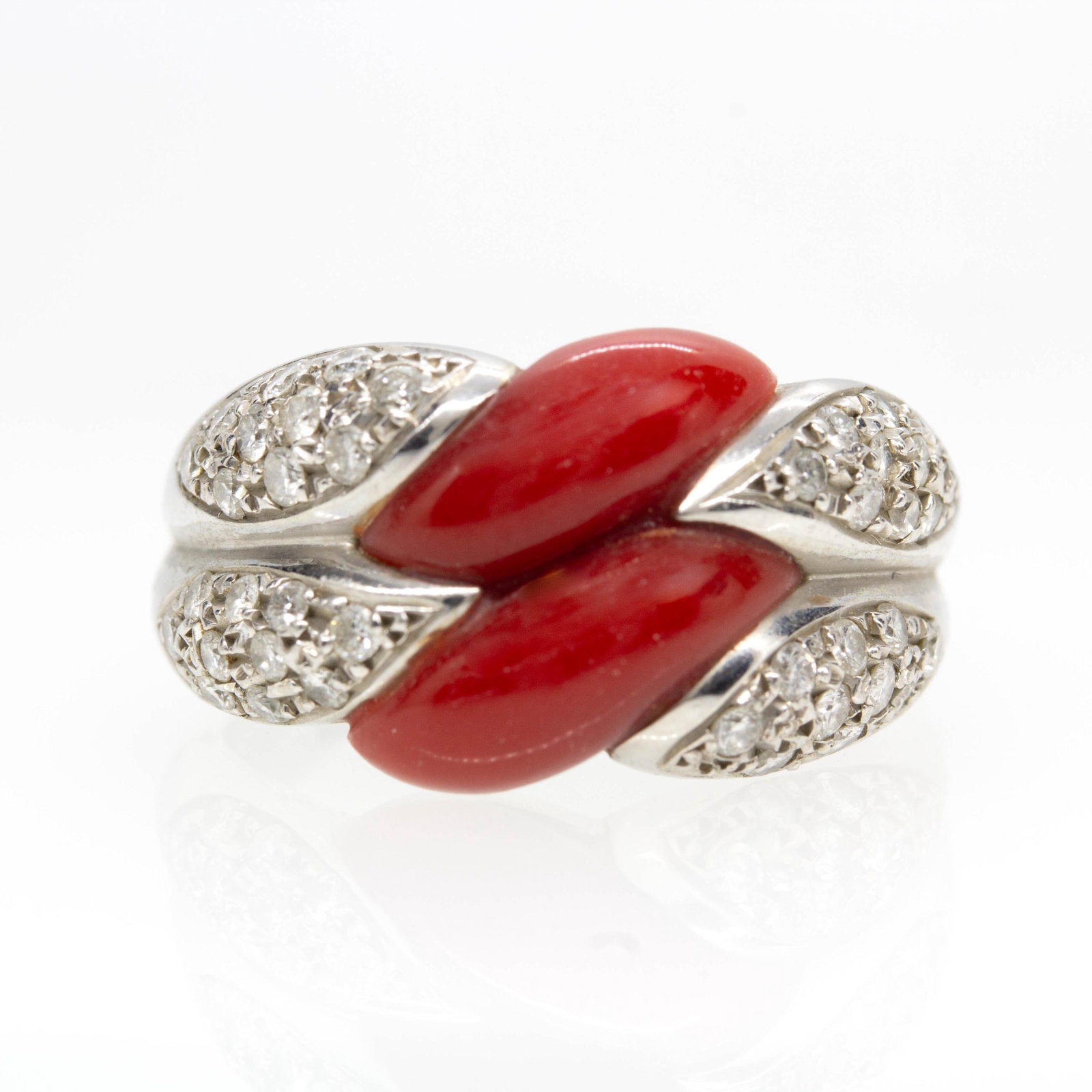 Estate Platinum Natural Coral and Diamond Designer Ring: Title: Estate Platinum Natural Coral and Diamond Designer Ring Description: The Madalynn ring is originally handmade in platinum. It displays 2 natural corals and 40 natural full cut diamonds of H