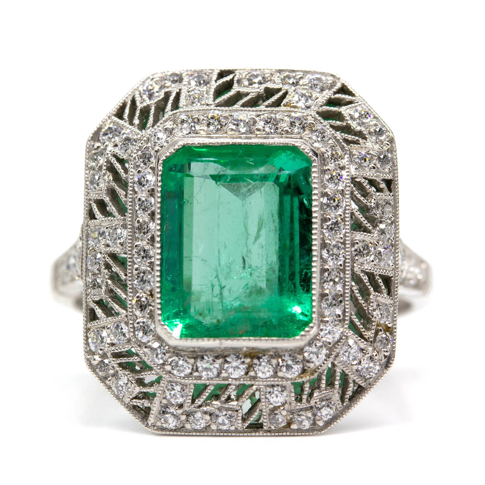 Art Deco Platinum Natural Emerald and Diamond Ring: Title: Art Deco Platinum Natural Emerald and Diamond Ring Description: The Daphne ring was handmade in platinum and centers one natural Colombian emerald that weighs 2.70ctw which is surrounded by 76 