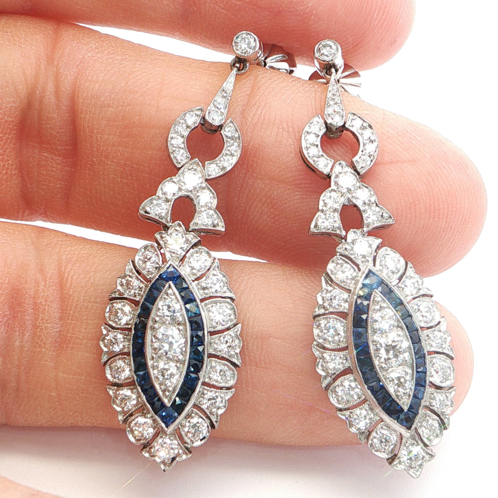 Platinum Dangle Earrings with Diamonds and Natural Blue Sapphires: Title: Platinum Dangle Earrings with Diamonds and Natural Blue Sapphires Description: Exquisite dangle earrings, crafted in platinum which showcase 70 old mine cut diamonds of H color and VS1 clarity